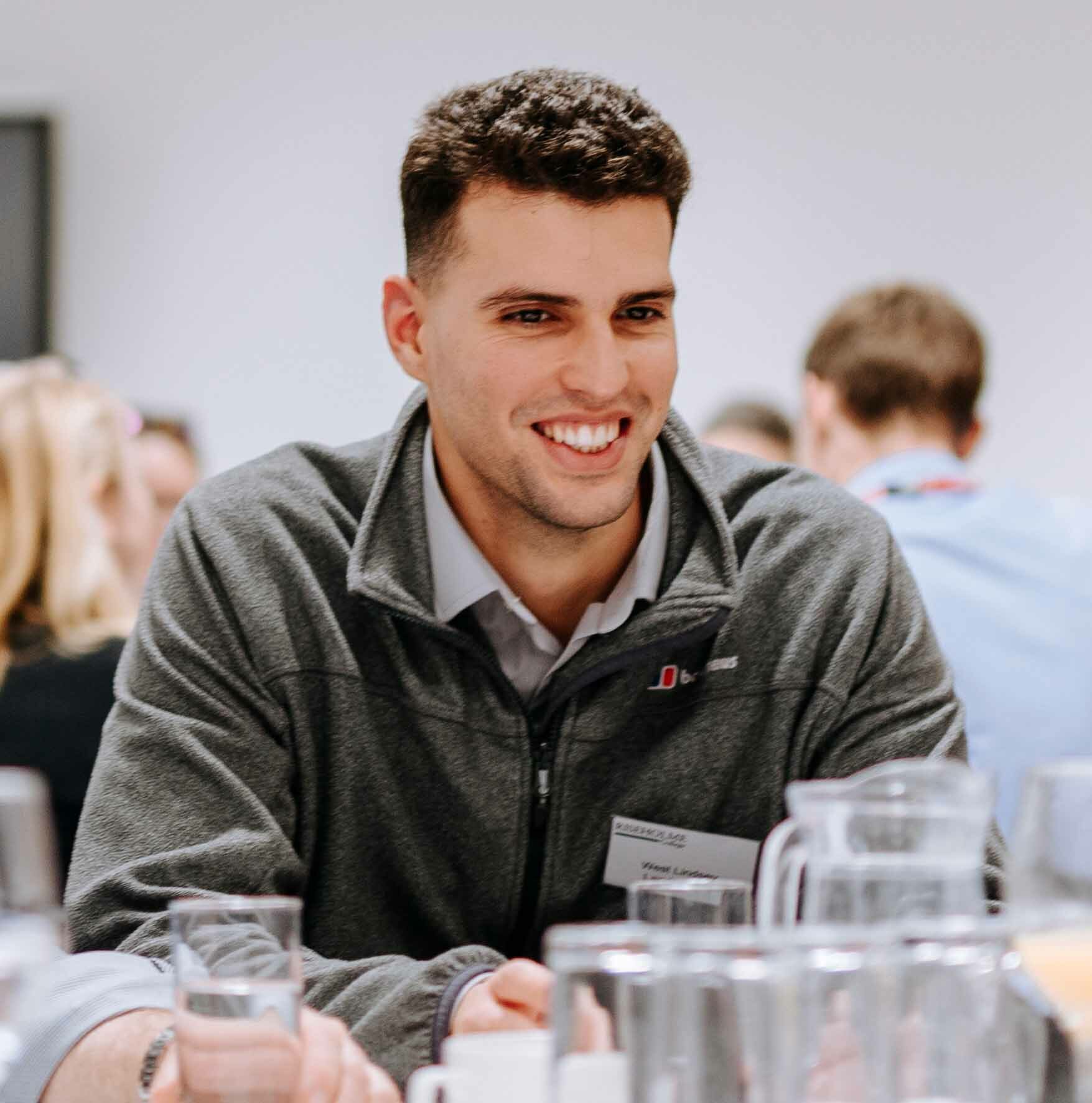 Delegates sat around table networking thumb