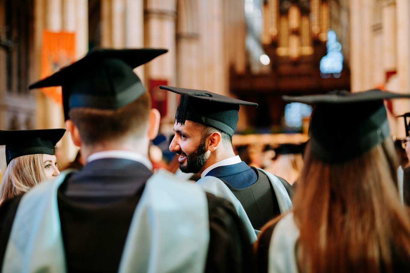 Gradutes chatting at ceremony
